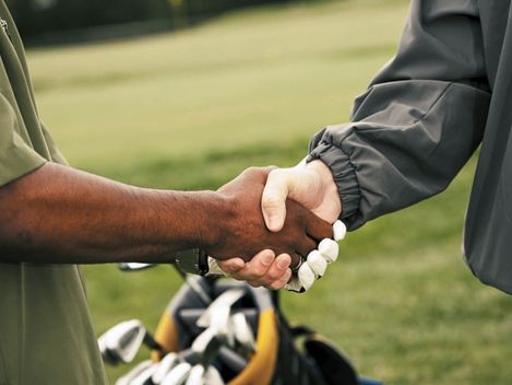 two golfers giving a handshake